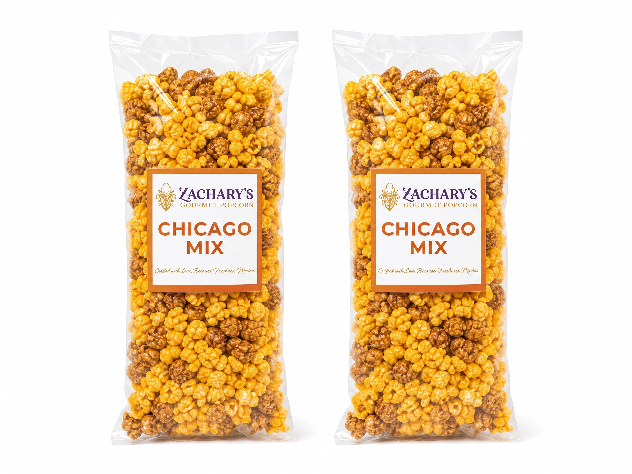 Two large party-size bags of Zachary's Chicago Mix gourmet popcorn, caramel and cheddar kernel blend with orange and white label