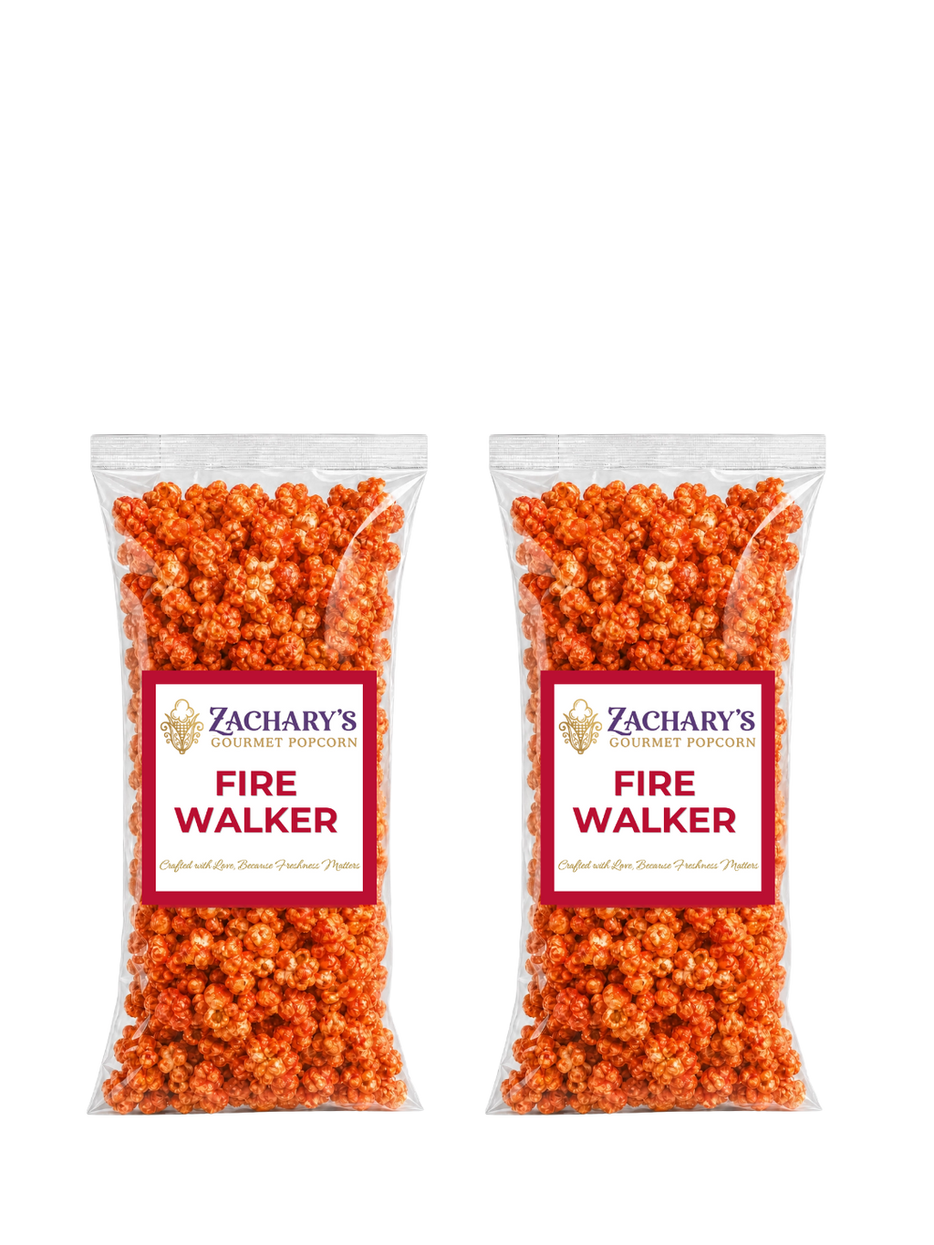 Two bags of Zachary's Fire Walker gourmet popcorn side by side, orange spicy-coated kernels in clear bags with red and white labels
