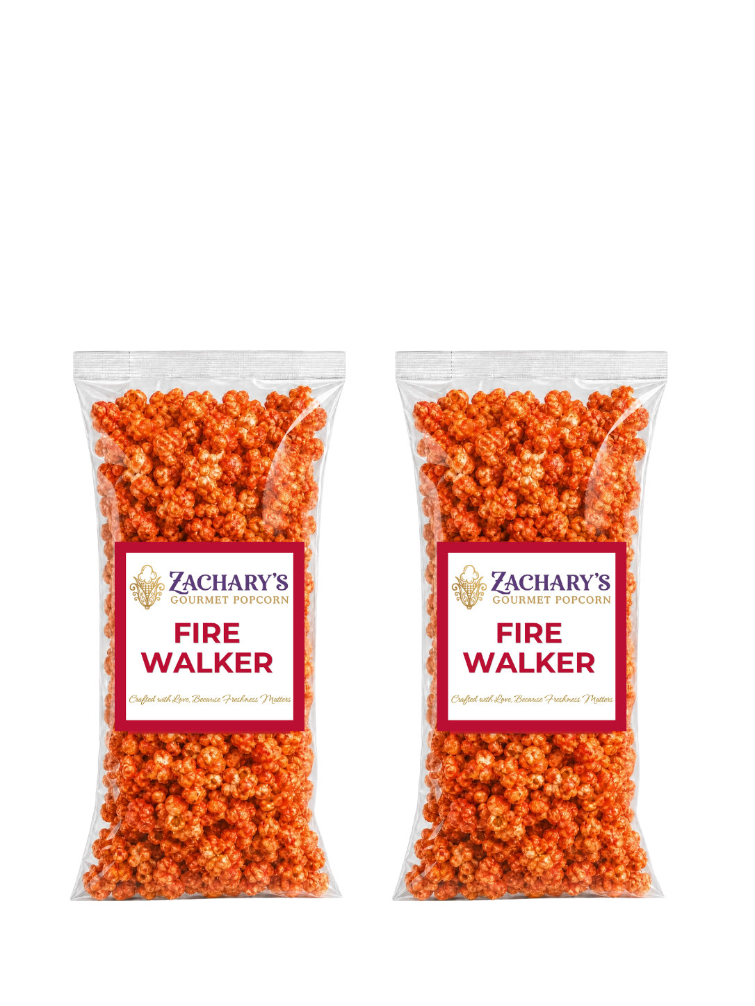 Two bags of Zachary's Fire Walker gourmet popcorn side by side, orange spicy-coated kernels in clear bags with red and white labels