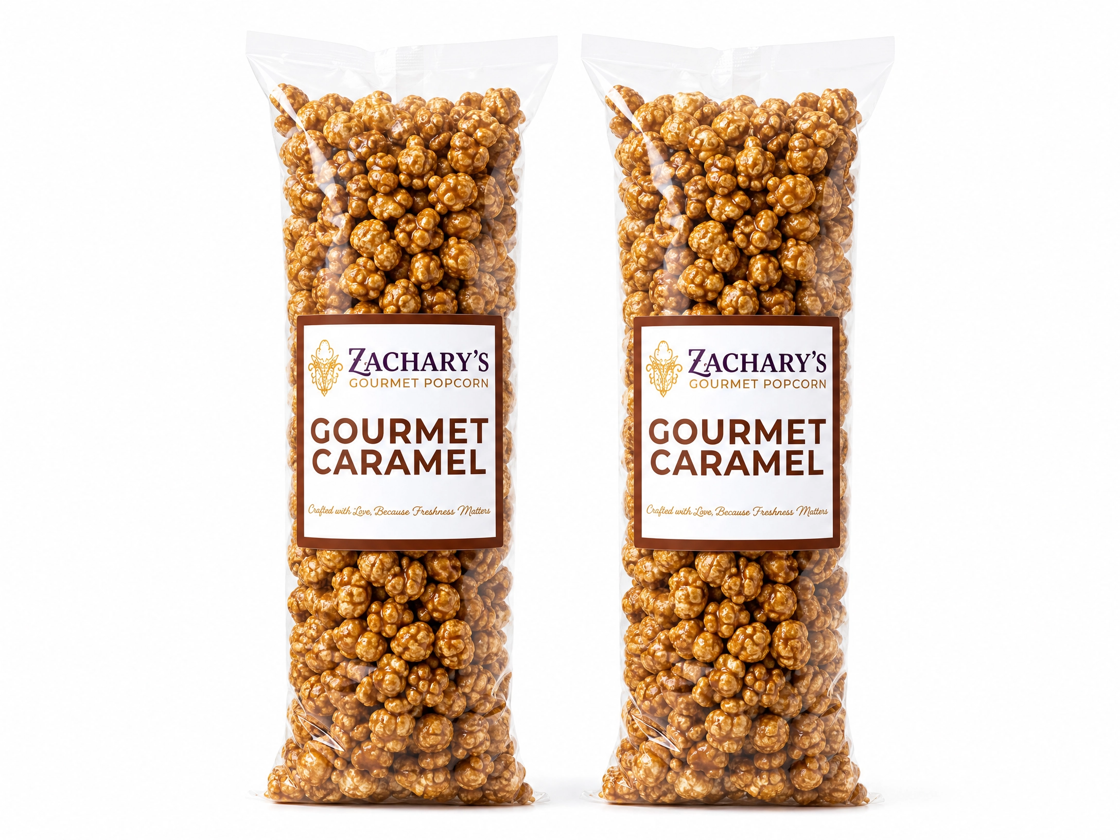 Two large bags of Zachary's Gourmet Caramel popcorn, glossy golden-brown caramel-coated kernels with brown and white label